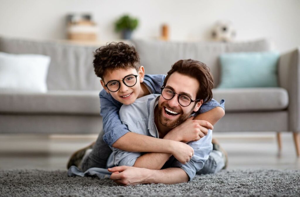 A parent & child wearing glasses to manage their hyperopia & myopia