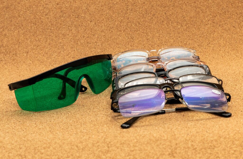 Various types of glasses resting next to each other on a wood background