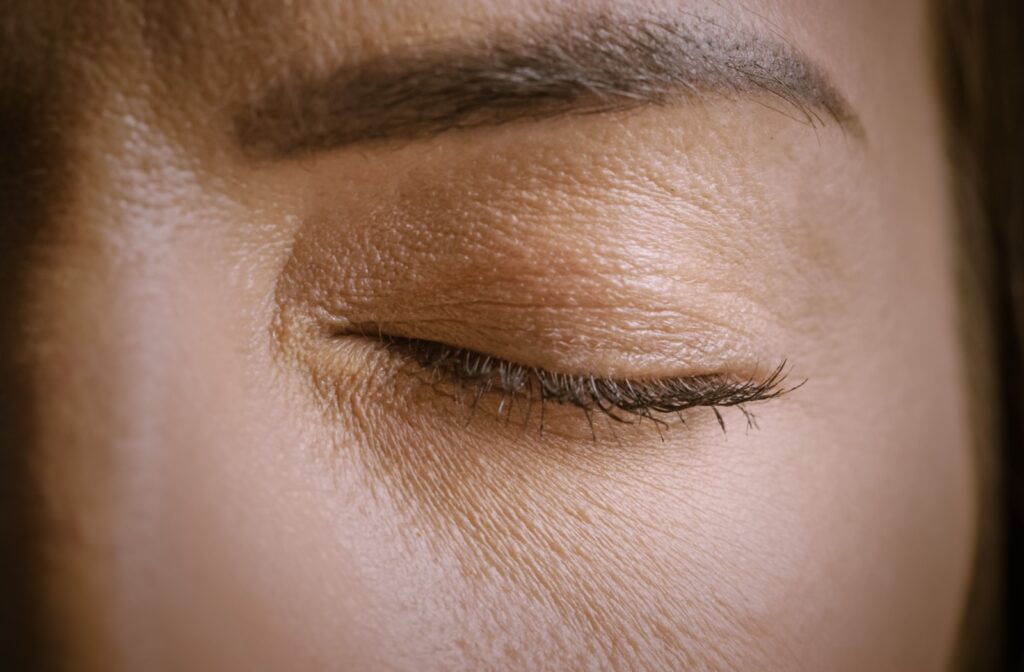 A close up of a persons closed eye as they blink