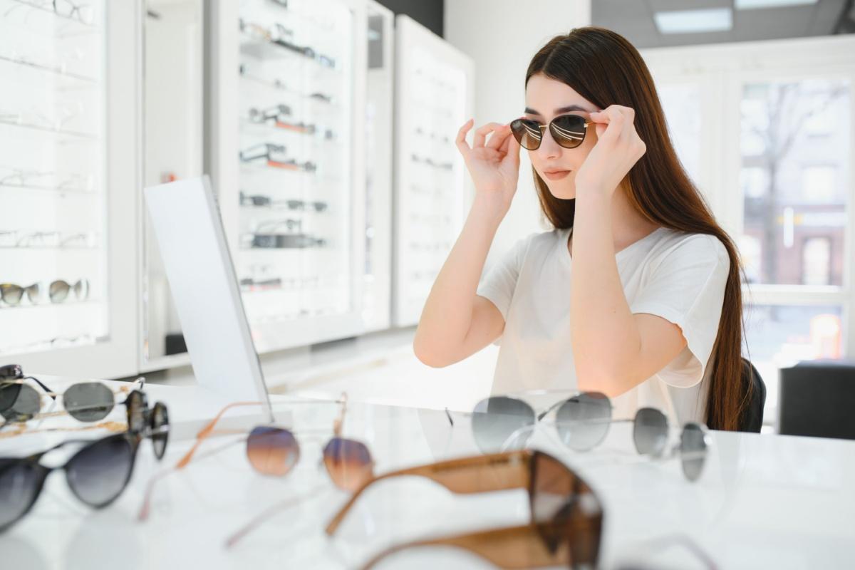 A person trying on a pair of sunglasses at the optometrists